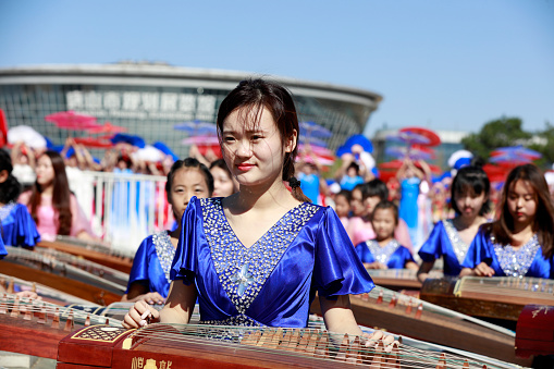 Tangshan City, China - October 7, 2018: Guzheng playing performance in the park, Hebei Province, China