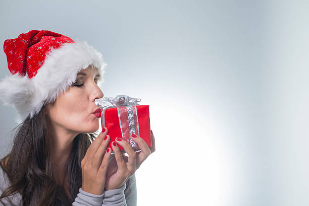 istock Beautiful woman in a red santa hat 186962684