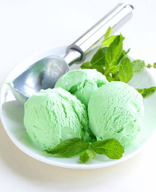 balls mint ice cream with fresh green herb