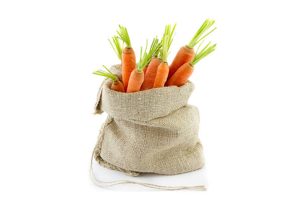 carrots in a burlap sack isolated on white