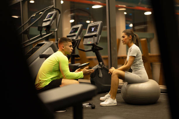istock Fitness trainer talking to his client 1869655449