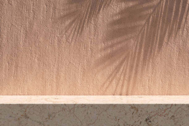 istock Light pink colored marble rectangle table podium or showcase with textured stucco wall background. 1869657063