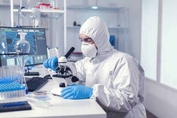 istock Doctor looking at sample of coronavirus 1869659771