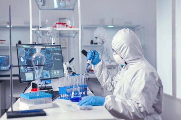 istock Concentrated scientist using micropipette with a test tube 1869663518
