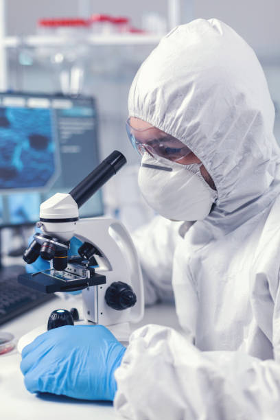 istock Close up of chief researcher scientist adjusts microscope 1869668415