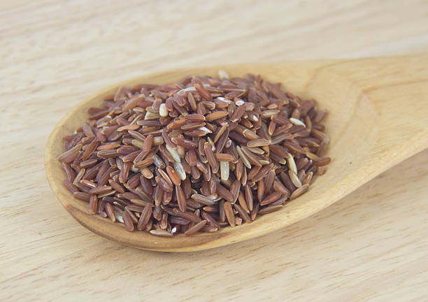 istock Brown rice with wooden spoon. 186966895