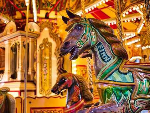 York, UK - Nov 23 2023: A closeup of a horse on a traditional merry-go-round fun fair ride run by G Warrington & Sons at York Christmas markets in northern UK.