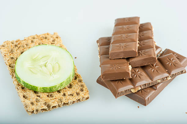 Chocolate or cracker cracker with slice of cucumber next to pieces of chocolate Ryvita stock pictures, royalty-free photos & images