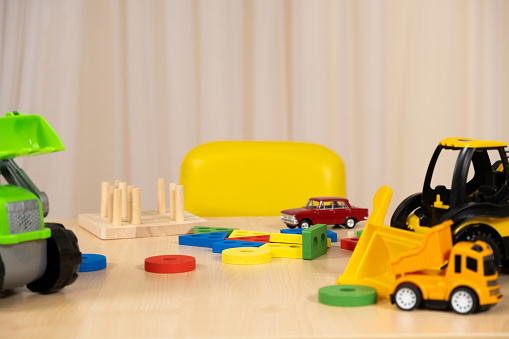 Toys of a small child - wooden blocks for the development of logic and thinking and construction machines, a place for text