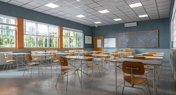 Diverse group of young students doing a visualization exercise with their eyes closed while sitting in a school classroom