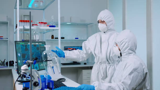 istock Biotechnology scientist wearing ppe suit researching 1869725390