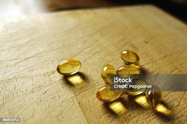 Healthy Cod Liver Oil Capsules In A Domestic Kitchen Setting Stock Photo - Download Image Now
