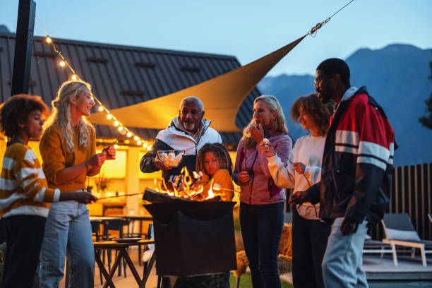 istock Happy Time Together Roasting Marshmallows At The Afternoon Outside 1869727587