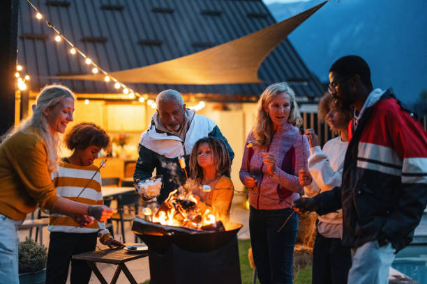 istock Multiracial Family Enjoying Some Grilled Marshmallows Outside At Night 1869727595