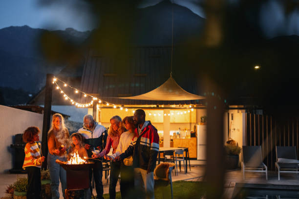 istock Nice Family Moments Roasting Marshmallows At Night 1869727597