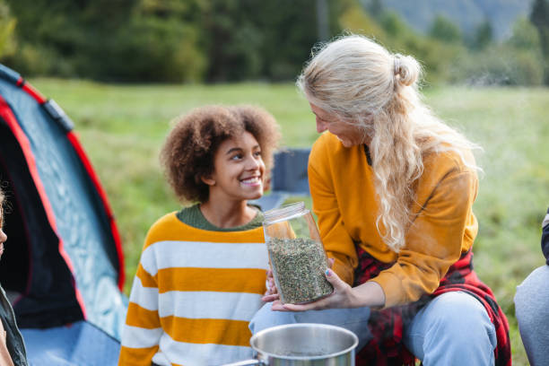istock A Caucasian Mother Holds A Jar With Coffee Grains Next To Her Multiracial Daughter While Cooking Some Coffee Together Outside 1869728116