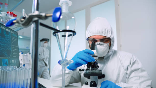 istock Researcher in ppe suit conducting DNA experiments 1869735248