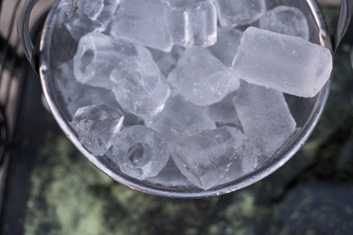 Metal bucket with ice cubes service in Thai restaurant.