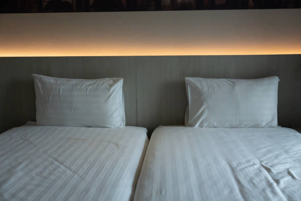 istock Two bed of clean bedding sheets and pillow 1869742277