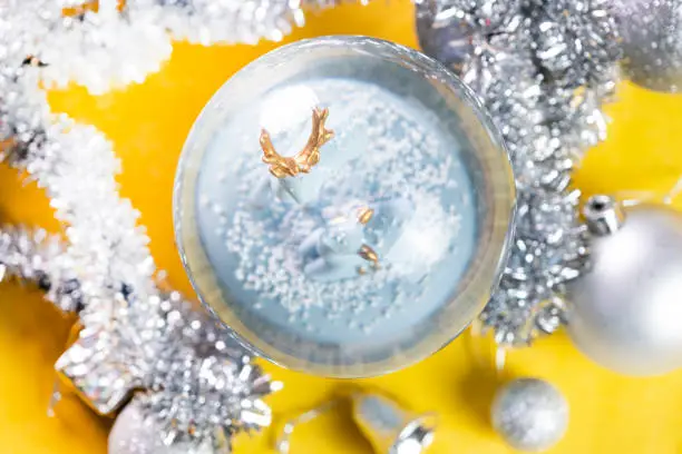 Photo of Christmas Snow Globe with Christmas ornaments and gift boxes