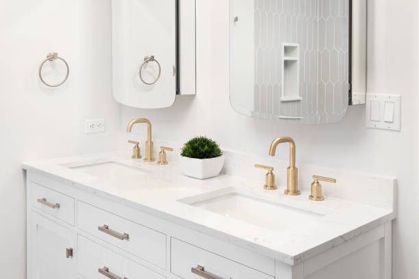 istock A white bathroom with gold faucets. 1869751853