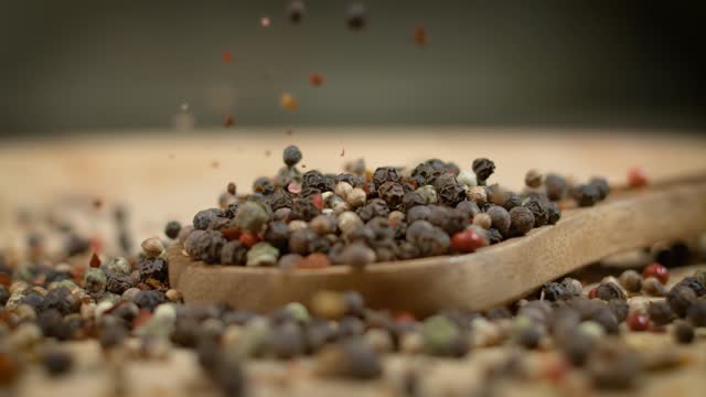 Mixed peppercorns in a super slow motion. Dry mix peppercorns close up.