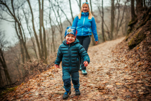 A mother and her son hiking and having fun a trail