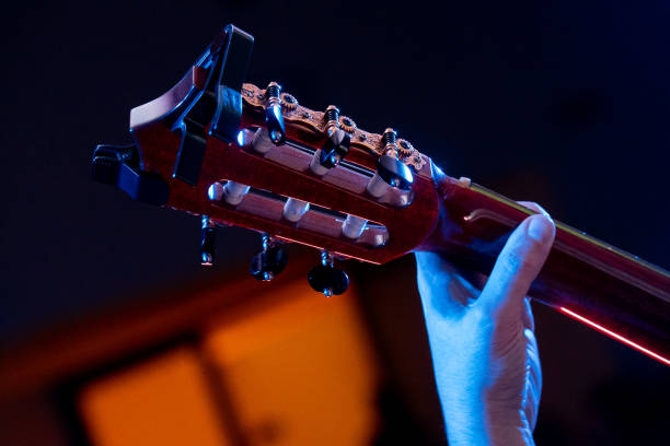 istock Close-up of hands playing chords. 1869766974