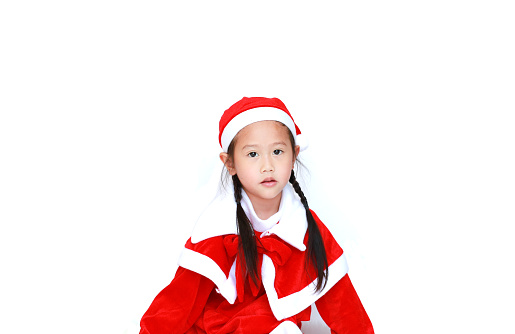 child girl in Santa costume dress with copy space on white background. Merry Christmas and Happy New Year Concept.
