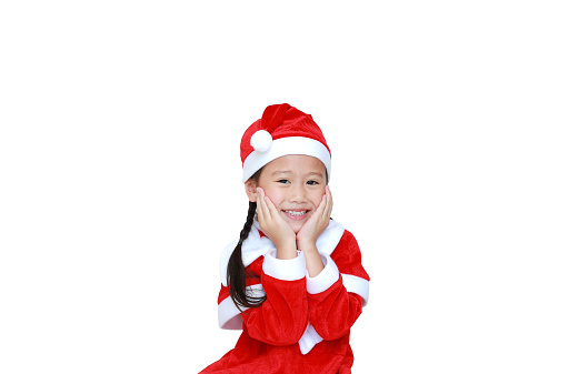 Happy child girl in Santa costume dress with copy space on white background. Merry Christmas and Happy New Year Concept.