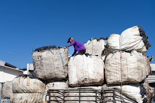 A worker unloads bags of plastic bottles to a sorting and compacting facility in Bang Phli, Samut Prakan, Thailand on December 20, 2023. Thailand is one of the world's biggest polluters. Out of the 8 million tons of waste the country generates, only 25% is recycled, and over 50,000 tons end up in the ocean every year. However, the Thai Government implemented a plan to ban all plastic imports by 2025, which has already resulted in a decrease in imported plastic into the Kingdom, which imported 180,000 tons in 2022.