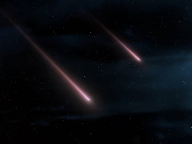 istock Two fireballs glow at night. Meteors in the starry sky. 1869780115