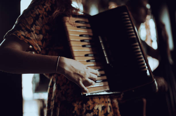 istock A woman playing the accordion. 1869785632