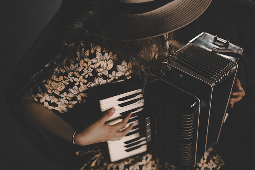 A woman playing the accordion. Musical background.