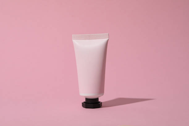 istock Pink tube with cream on pink background 1869794065
