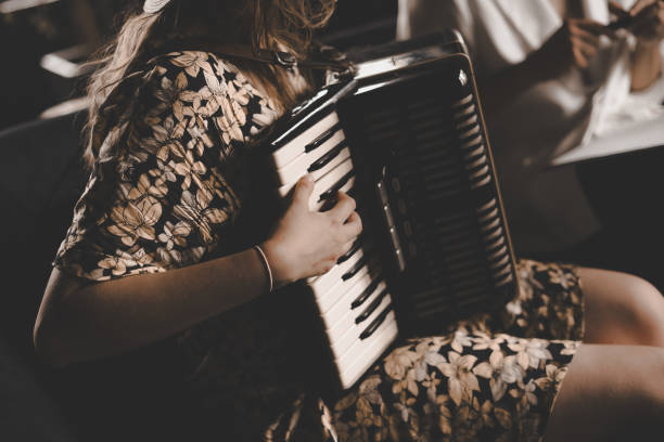 istock A woman playing the accordion. 1869795129