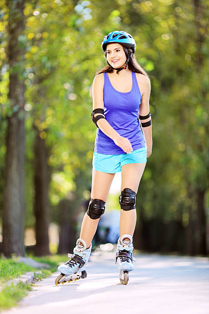 istock Young smiling female on rollers skating in a park 186980344