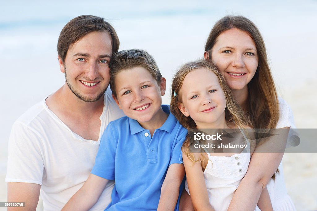 Family on a tropical beach vacation Happy beautiful family on a tropical beach vacation Adult Stock Photo