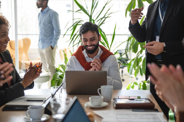 istock Mixed-Race Worker Clappling To His College Project Explanation 1869809572