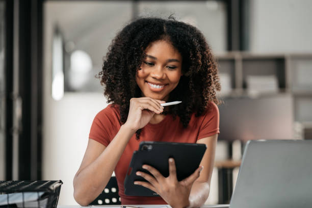 Elearning online working concept. Business man working on laptop computer, searching and taking note on paper notebook with pen working in office. Elearning online working concept. Business man working on laptop computer, searching and taking note on paper notebook with pen working in office. woman trading stocks stock pictures, royalty-free photos & images