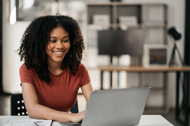 istock Businesswomen hand working with tablet and laptop computer with documents on office desk in modern office. 1869817748