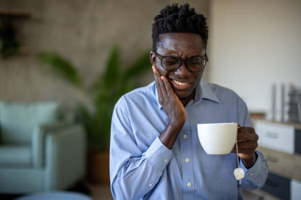 istock Young man drinking tea and experiencing teeth pain 1869825932