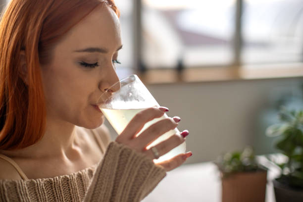 istock Woman drinking juice at home 1869828584