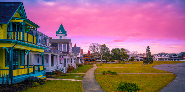 Oak Bluffs skyline, well-preserved landmark houses, and dramatic winter sunset cloudscape over the Ocean Park on the island of Martha's Vineyard in Dukes County, Massachusetts, United States, a popular travel destination for summer tourists.