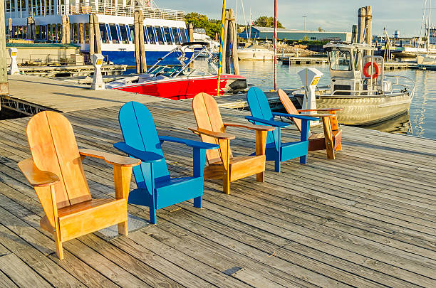 istock Line of Andirondack Chairs on a Jetty 186984898