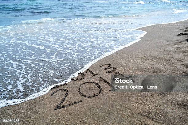 2013 2014 Written In The Sand Getting Washed Out By Ocean Stock Photo - Download Image Now