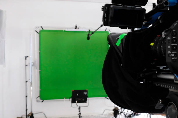istock TV studio with green screen, lights, and camera 1869866011