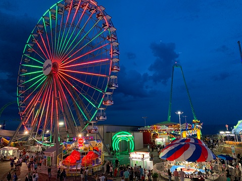Seaside Heights, NJ, USA July 6 The Ferris wheel and other amusement park rides are illuminated on Casino Pier, during a Jersey Shore summer night in Seaside Heights New Jersey
