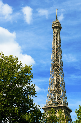 Eiffel Tower on blue sky background with cumulus clouds