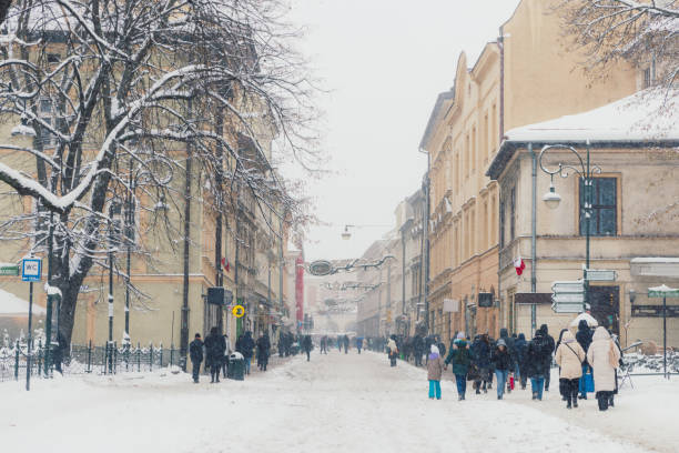 istock People Walking Old Streets of Krakow During Snowfall, Poland 1869870310